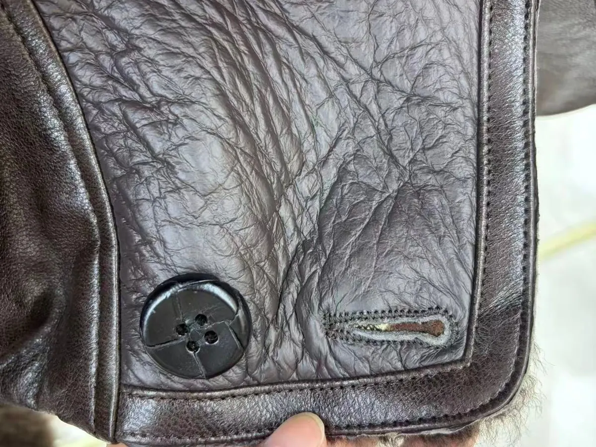 Real leather texture and button detail — fur garment quality check