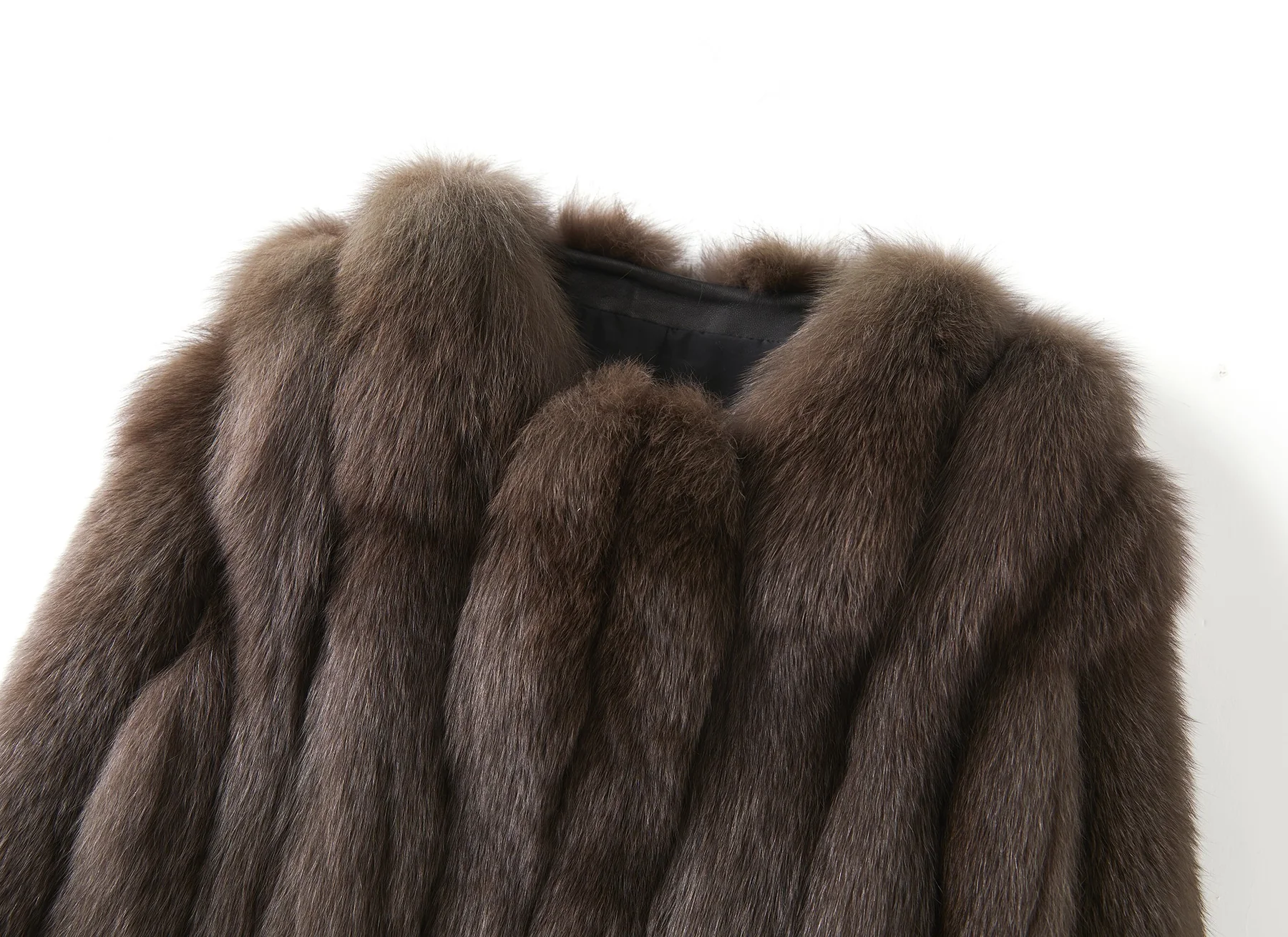 Close-up of a brown fox fur collar showing vertical pelt panels