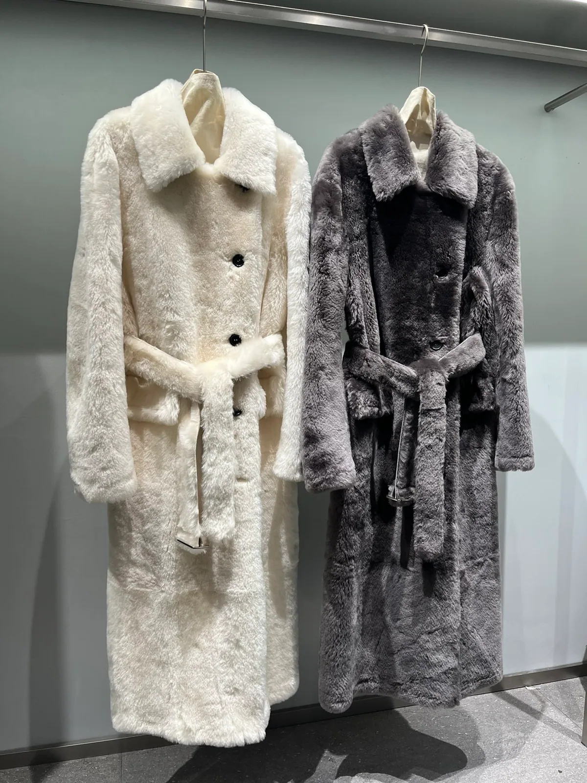 Long double-face shearling trench coats in ivory and grey