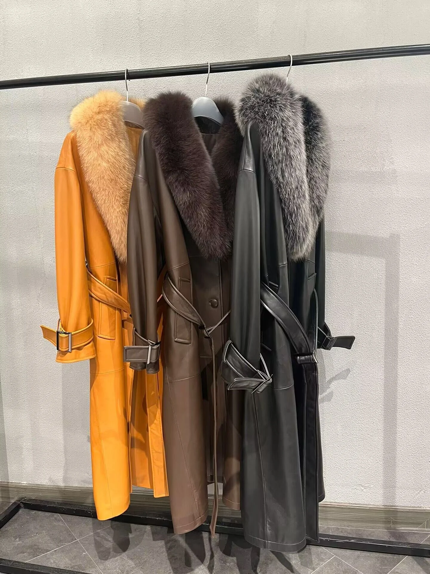 Orange brown and black long leather coats with fox-fur collars