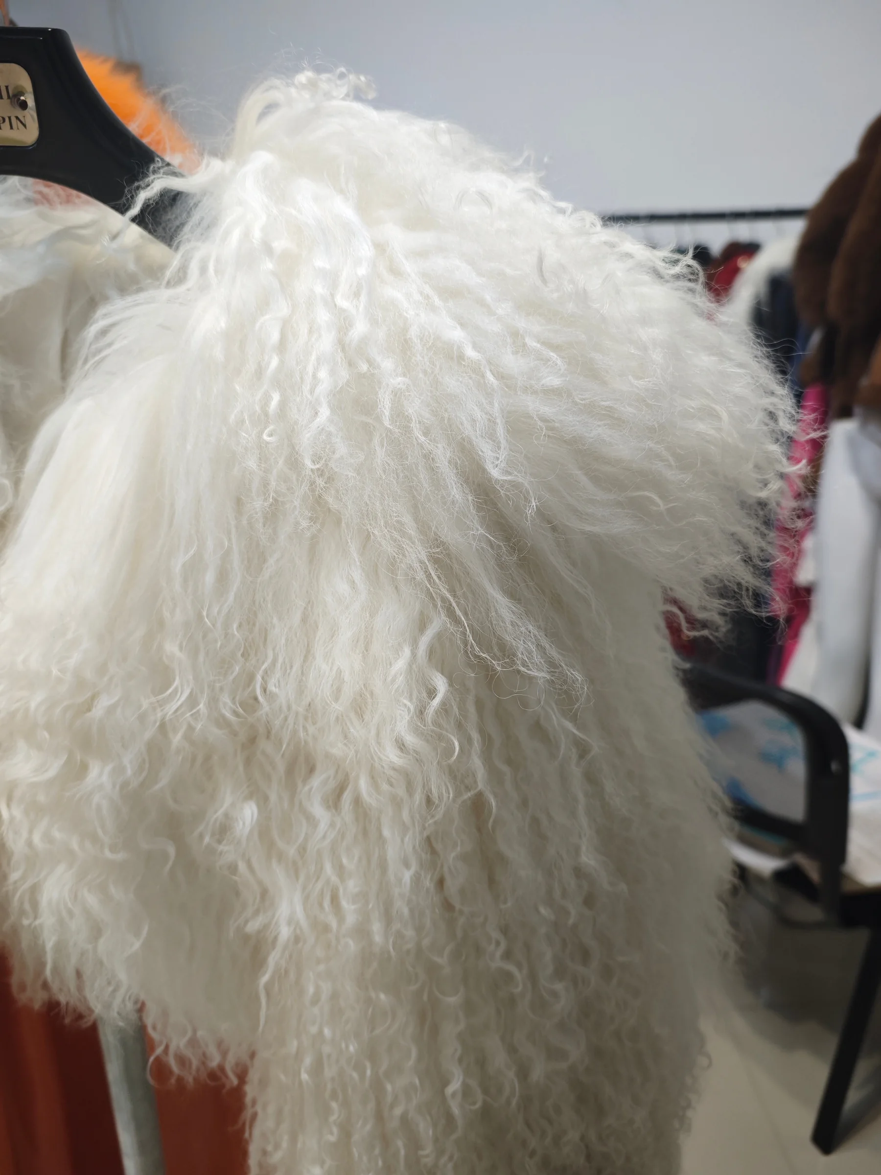White curly lamb fur material photographed in Umay Garment's showroom